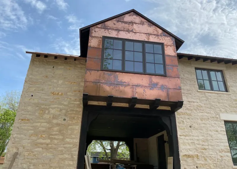Copper metal panel facade on a stone building for Skylight Installation in Beech Grove